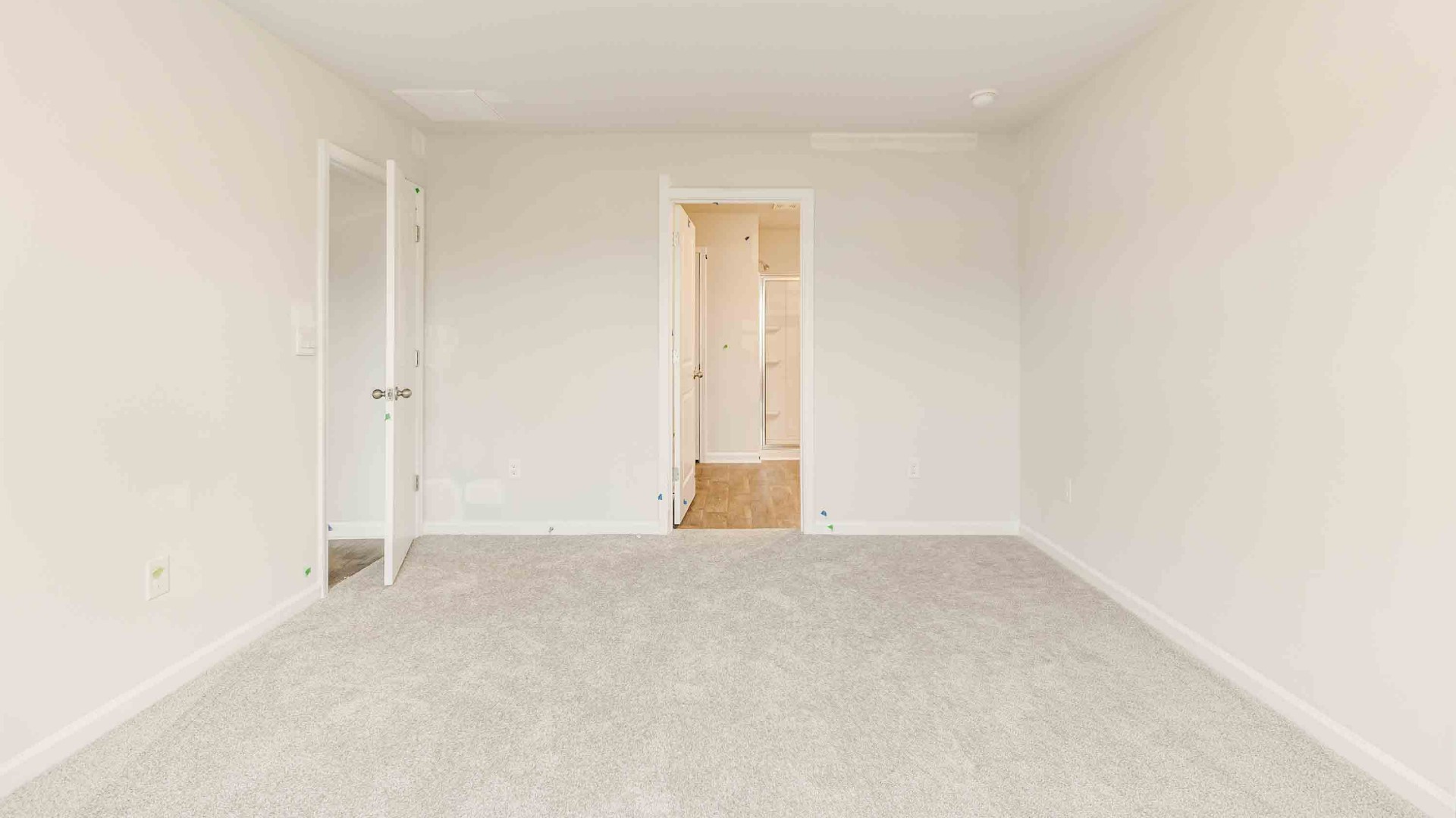 The primary suite is tucked away in the back of the home, offering a peaceful retreat complete with a walk-in shower, granite vanity, and a roomy walk-in closet.