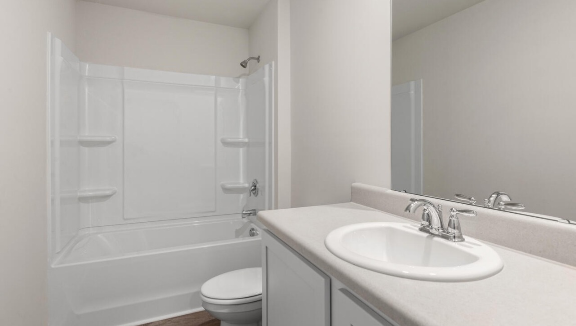 Need privacy? The primary suite is tucked away in the back of the home, offering a peaceful retreat complete with a walk-in shower, granite vanity, and a roomy walk-in closet. Three additional bedrooms are located up front- perfect for guests, kids, or a home office setup.  And don't forge