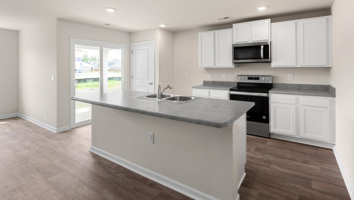 The kitchen is a showstopper with granite countertops, stainless steel appliances, and a big island perfect for entertaining or casual meals. You’ll never be too far from the action with the living and dining area right there.