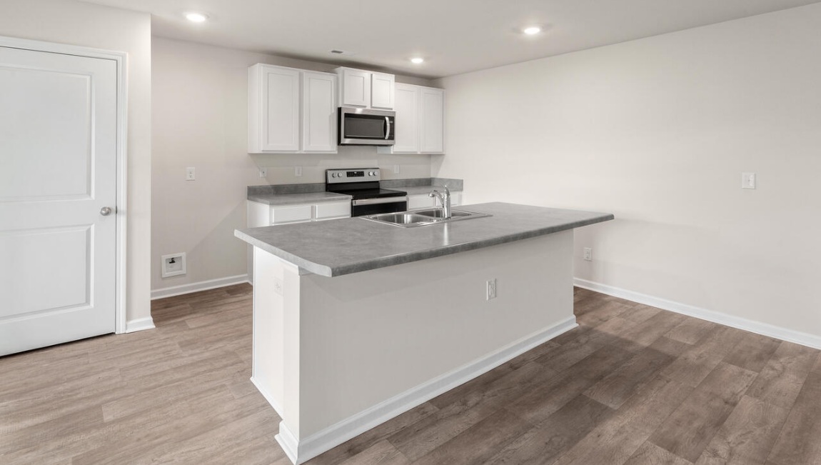 The kitchen is a showstopper with granite countertops, stainless steel appliances, and a big island perfect for entertaining or casual meals. You’ll never be too far from the action with the living and dining area right there.
