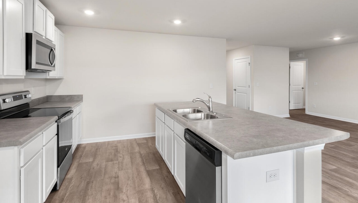 The kitchen is a showstopper with granite countertops, stainless steel appliances, and a big island perfect for entertaining or casual meals. You’ll never be too far from the action with the living and dining area right there.