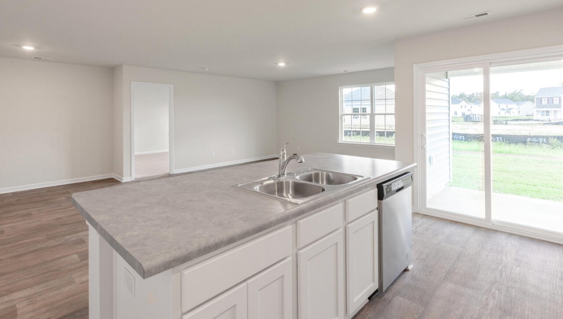 Need privacy? The primary suite is tucked away in the back of the home, offering a peaceful retreat complete with a walk-in shower, granite vanity, and a roomy walk-in closet. Three additional bedrooms are located up front- perfect for guests, kids, or a home office setup.  And don't forge