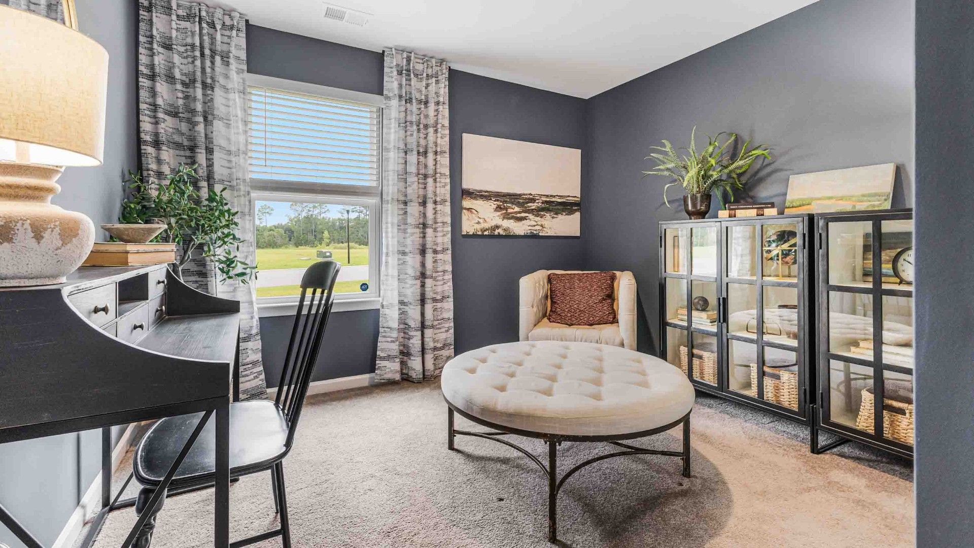 At the back, the Primary Suite provides privacy with a large walk-in closet and walk-in shower. This floor plan combines comfort and convenience, making it a great choice for those seeking an open layout and a 2-car garage.
