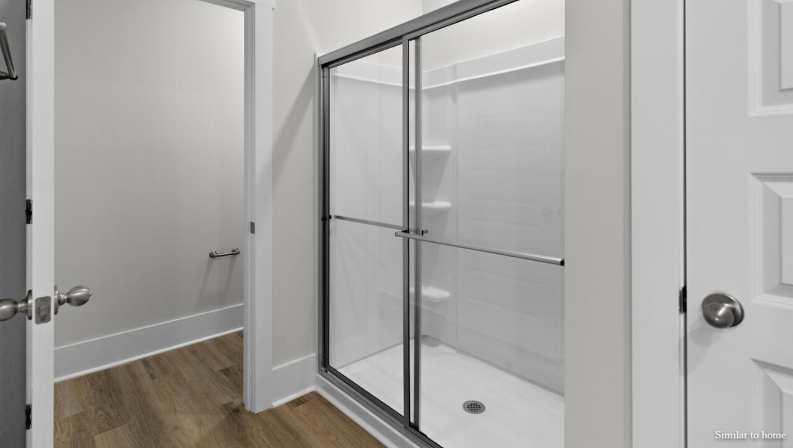 Your primary suite features a 5-foot tiled shower with a frameless glass door and dual vanities for a touch of everyday luxury.