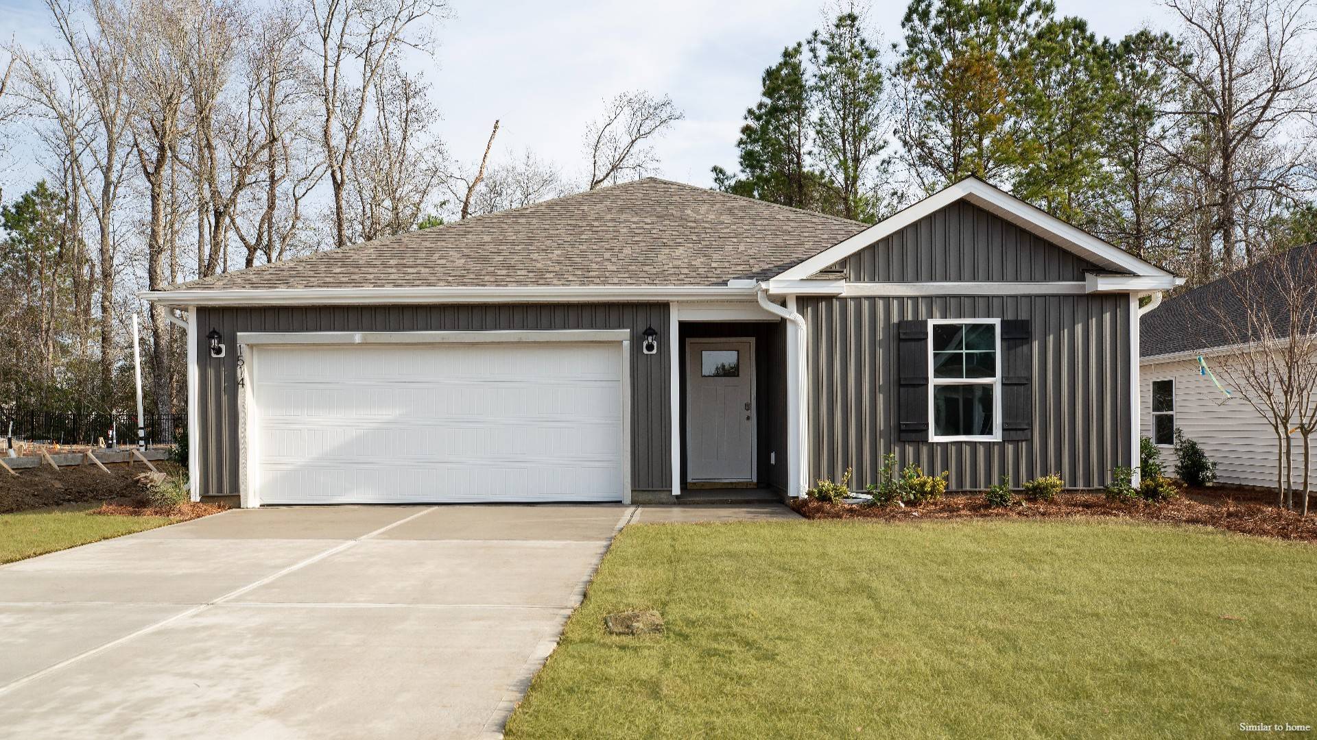 The Kerry floor plan offers open living space and a 2-car garage. At the front are two guest bedrooms and a full bathroom, perfect for visitors or a home office.