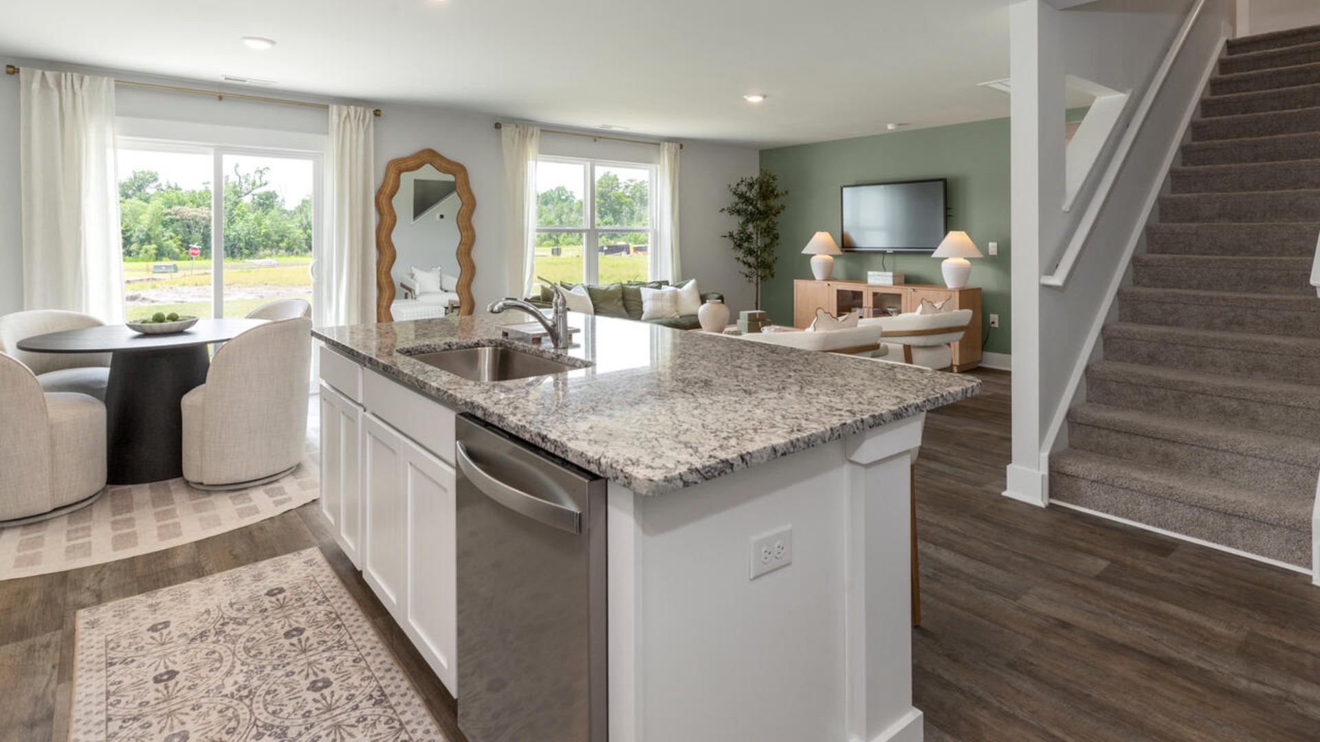 The open-concept kitchen features granite countertops and stainless steel appliances. The kitchen seamlessly connects to the dining and living areas, creating a great space for entertainment.