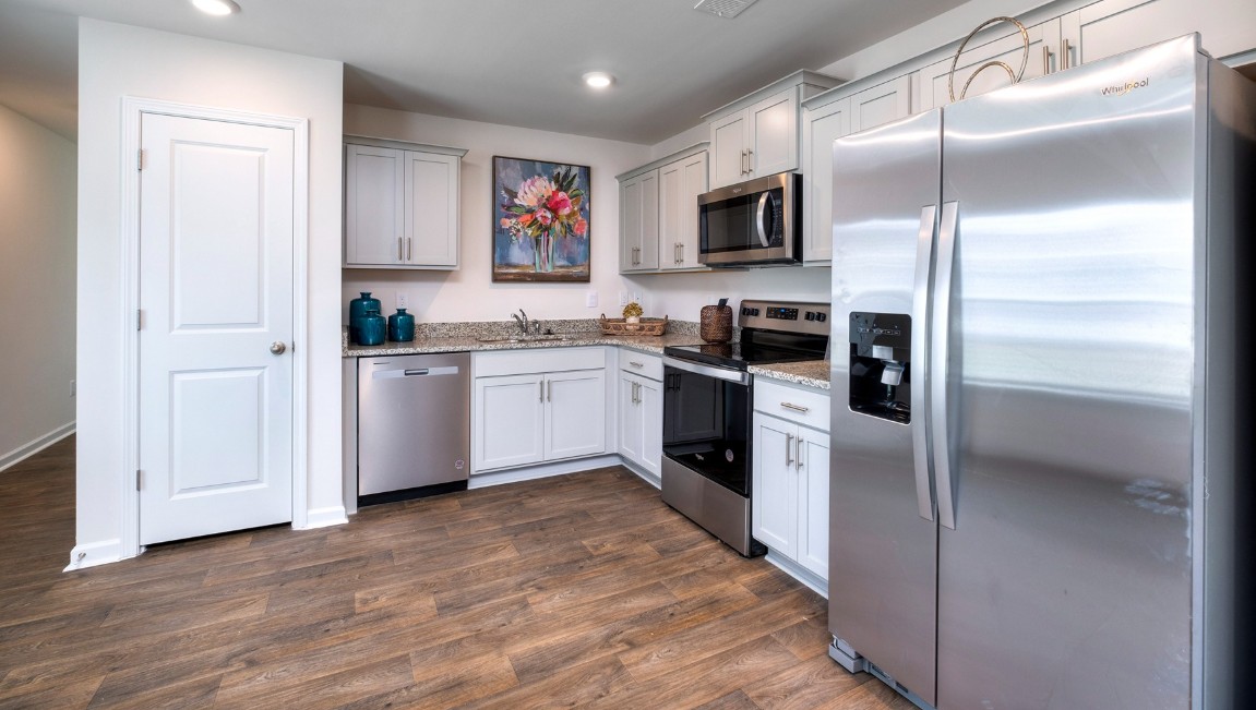 The kitchen features shaker-style cabinets, granite countertops, and stainless-steel appliances, which are sure to both turn heads and make meal prep easy. You’ll never be too far from the action with the living and dining area right there.