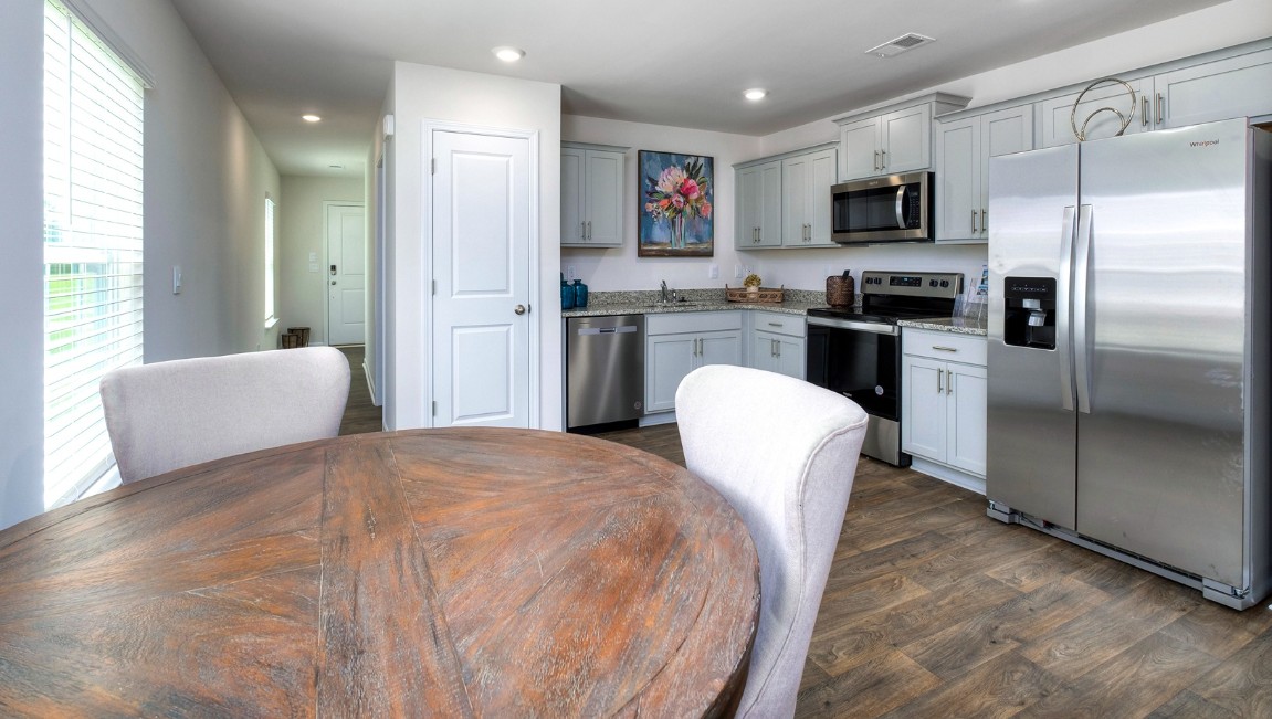 The kitchen features shaker-style cabinets, granite countertops, and stainless-steel appliances, which are sure to both turn heads and make meal prep easy. You’ll never be too far from the action with the living and dining area right there.