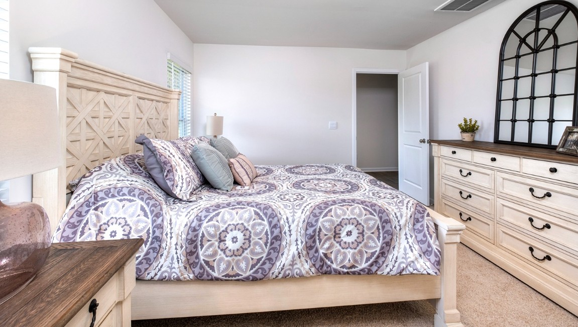 Bedroom One, located at the back of the house for privacy, also has a suite bathroom with double vanity and walk-in closet. Two other bedrooms share a second bathroom