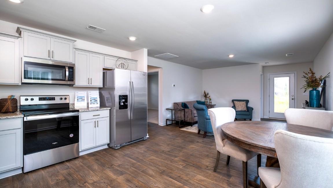The kitchen features shaker-style cabinets, granite countertops, and stainless-steel appliances, which are sure to both turn heads and make meal prep easy. You’ll never be too far from the action with the living and dining area right there.