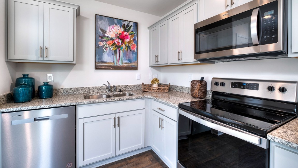 The kitchen features shaker-style cabinets, granite countertops, and stainless-steel appliances, which are sure to both turn heads and make meal prep easy. You’ll never be too far from the action with the living and dining area right there.
