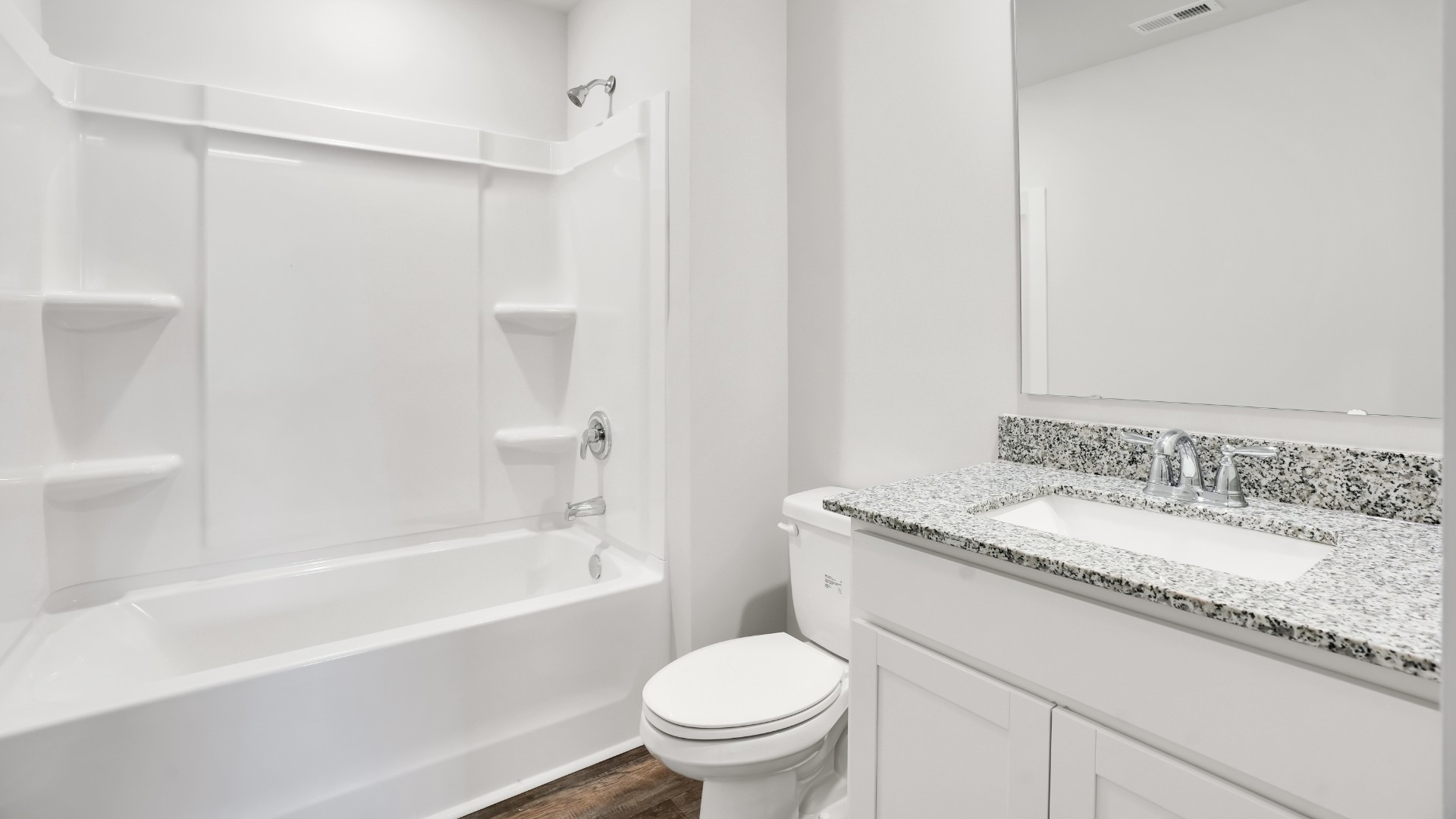 Bedroom One, located at the back of the house for privacy, also has a suite bathroom with double vanity and walk-in closet.