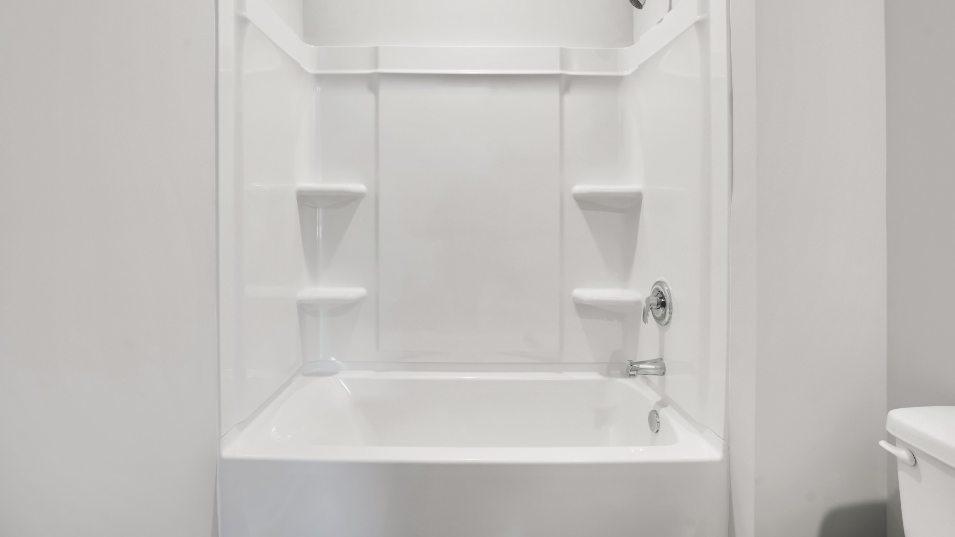 Bedroom One, located at the back of the house for privacy, also has a suite bathroom with double vanity and walk-in closet.