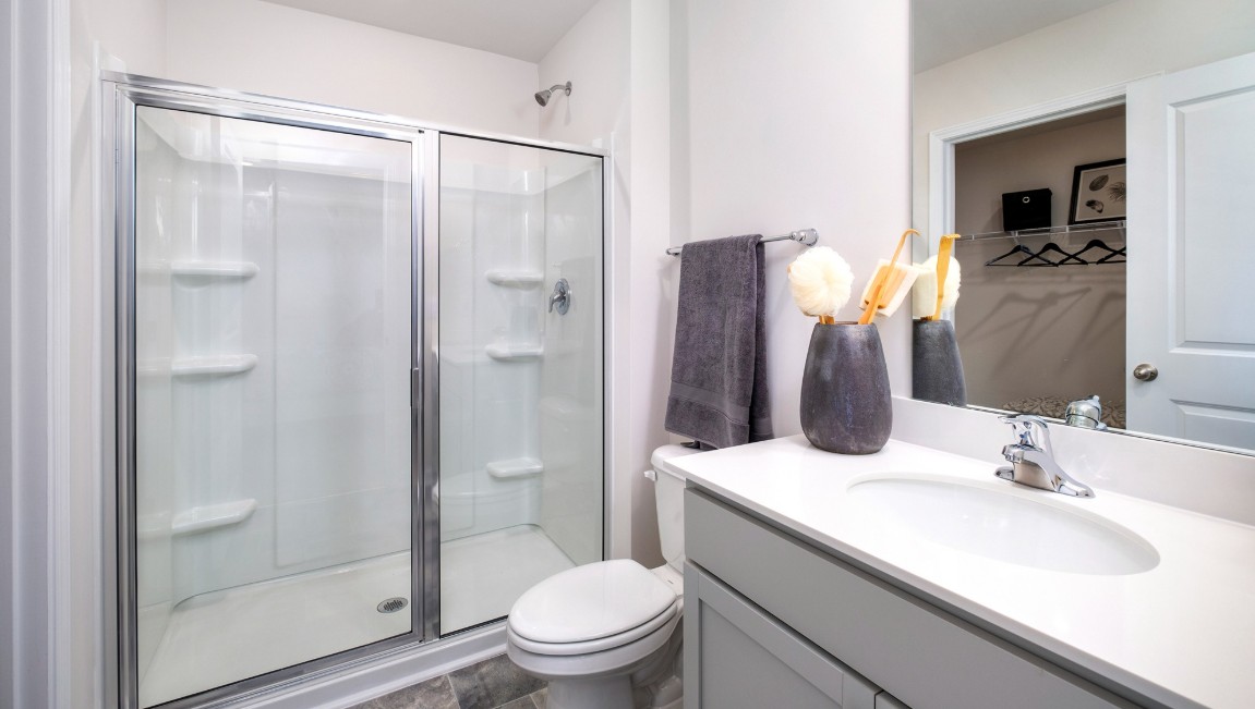 Bedroom One, located at the back of the house for privacy, also has a suite bathroom with double vanity and walk-in closet. Two other bedrooms share a second bathroom. The laundry room is located at the front of home near the two-car garage, quietly away from living areas and bedrooms