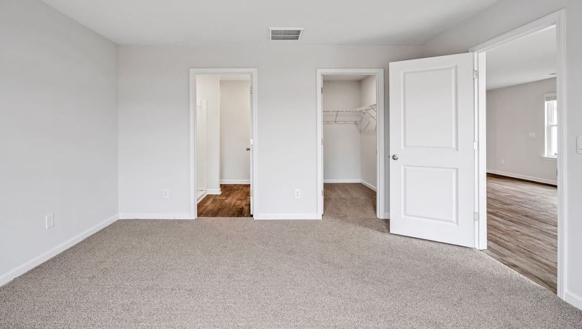 The primary bedroom features an ensuite bathroom with a double vanity, granite countertops, and walk-in closet .
