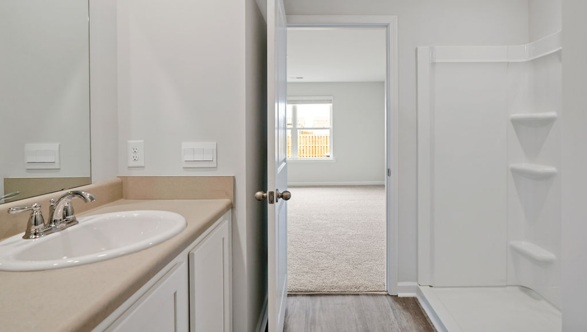 The primary bedroom features an ensuite bathroom with a double vanity, granite countertops, and walk-in closet .