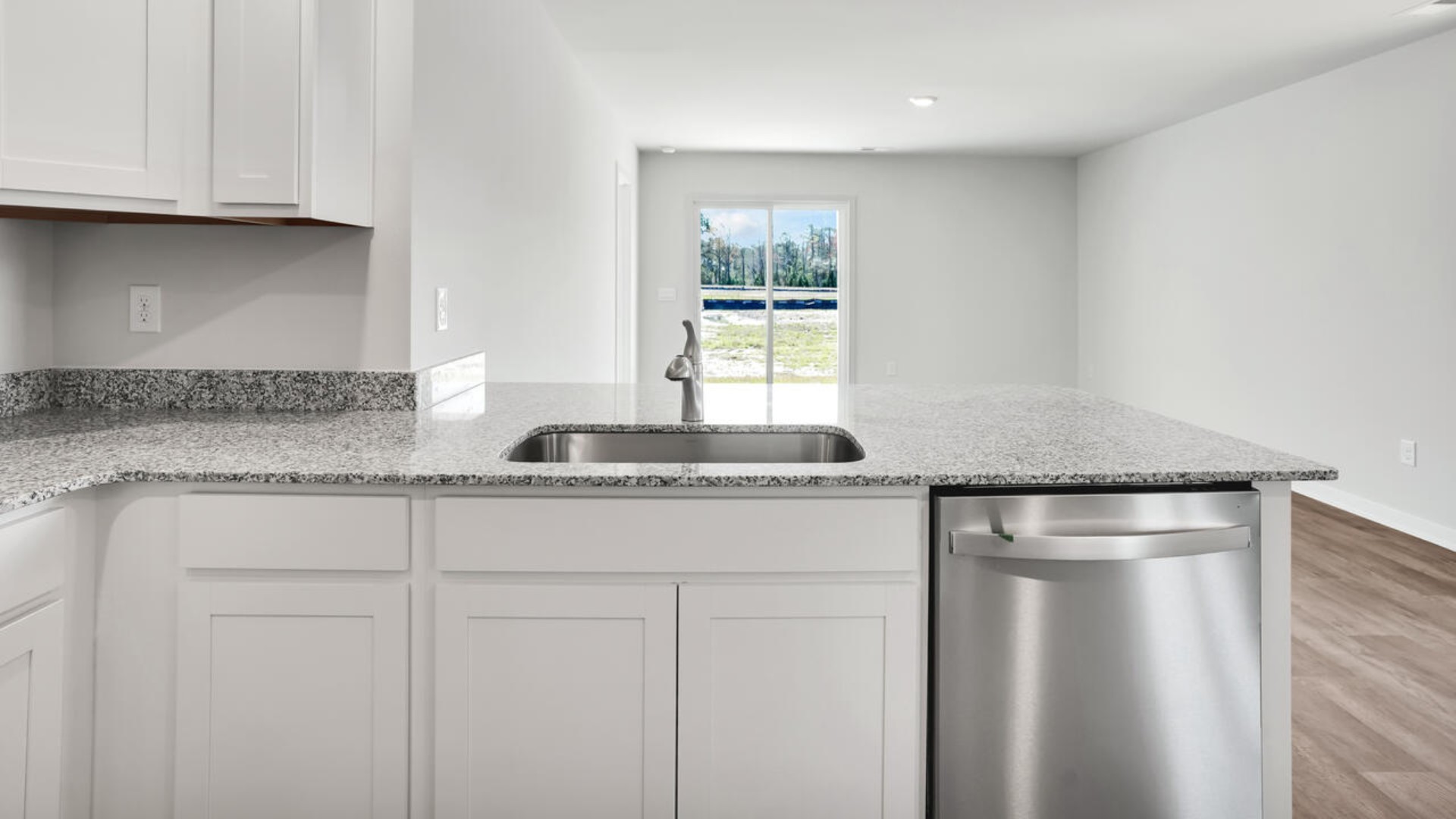 The kitchen is equipped for both efficiency and style with all stainless-steel appliances, including a range, built-in dishwasher, refrigerator, and microwave.