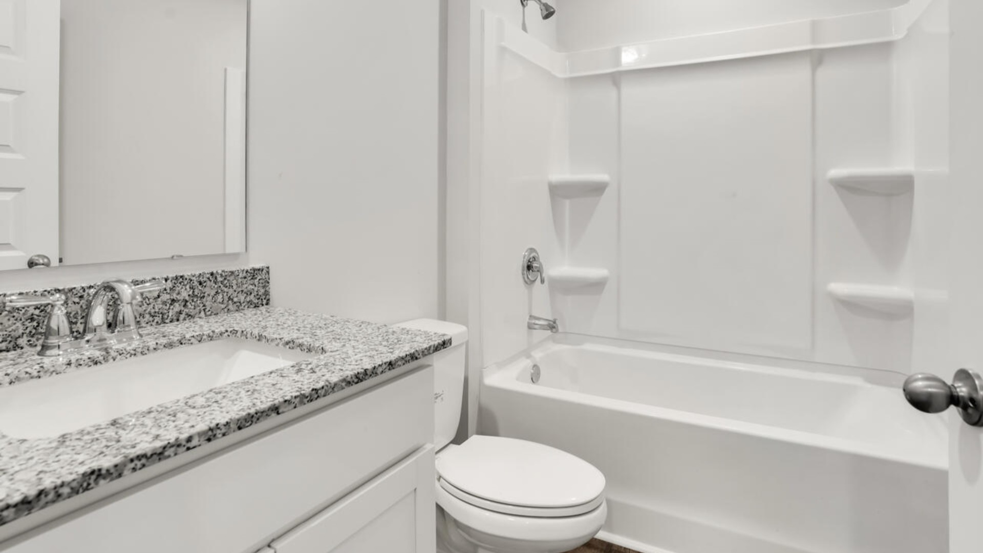 The primary bedroom features an ensuite bathroom with a double vanity, granite countertops, and walk-in closet.