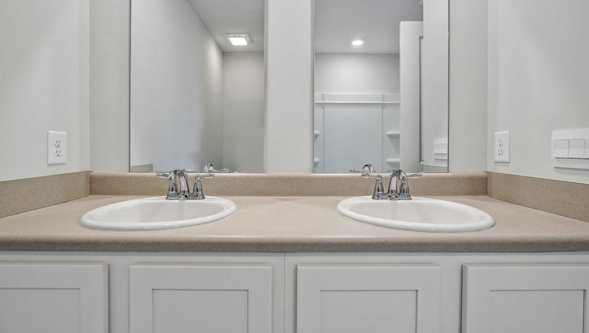 The primary bedroom features an ensuite bathroom with a double vanity, granite countertops, and walk-in closet.