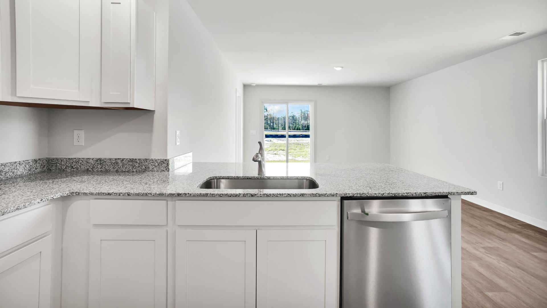 The kitchen is equipped for both efficiency and style with all stainless-steel appliances, including a range, built-in dishwasher, refrigerator, and microwave.