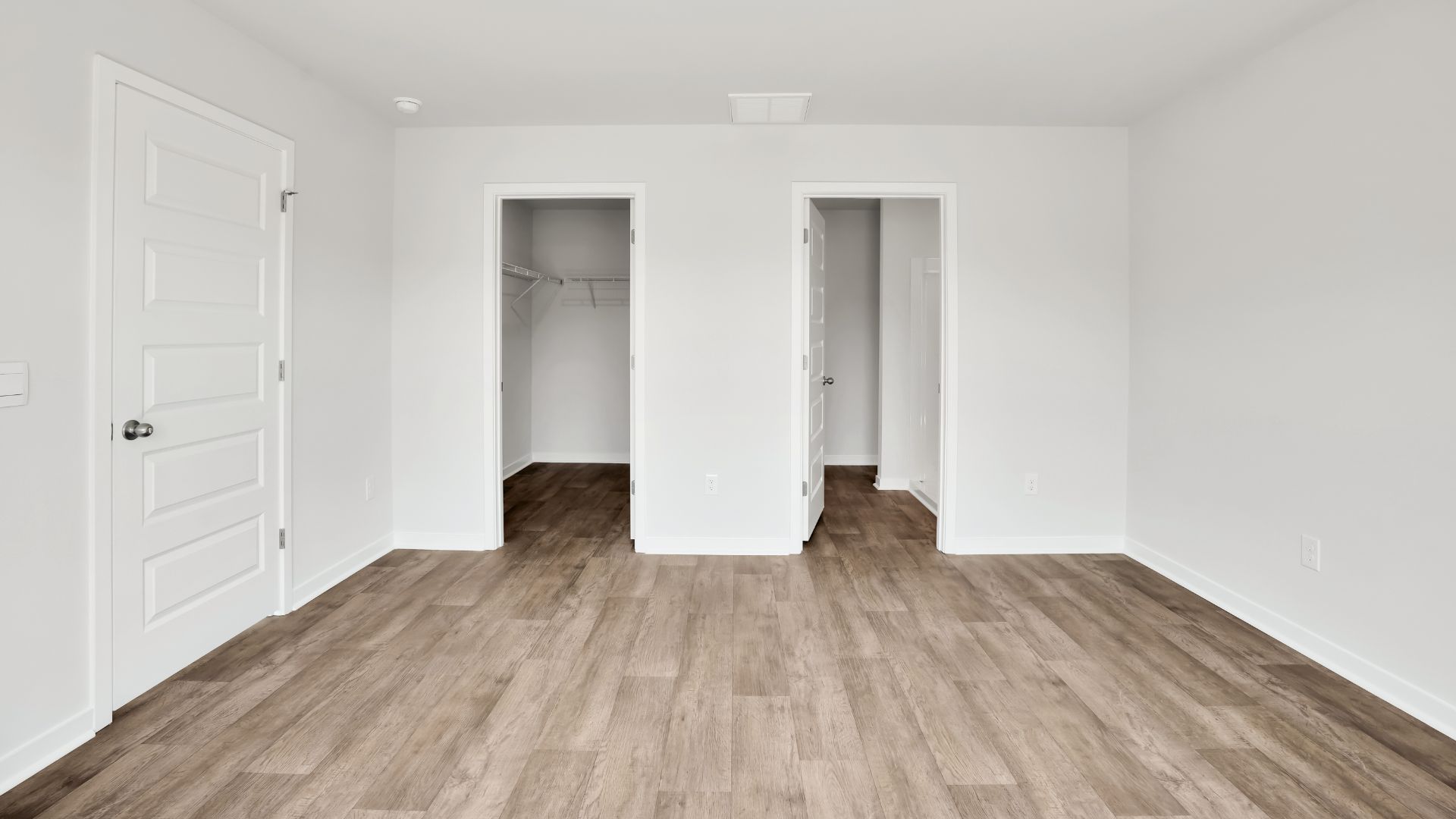 The primary bedroom features an ensuite bathroom with a double vanity, granite countertops, and walk-in closet. Each bedroom has vinyl flooring along with a closet that are versatile to fit your family's needs, whether they become bedrooms or home offices.