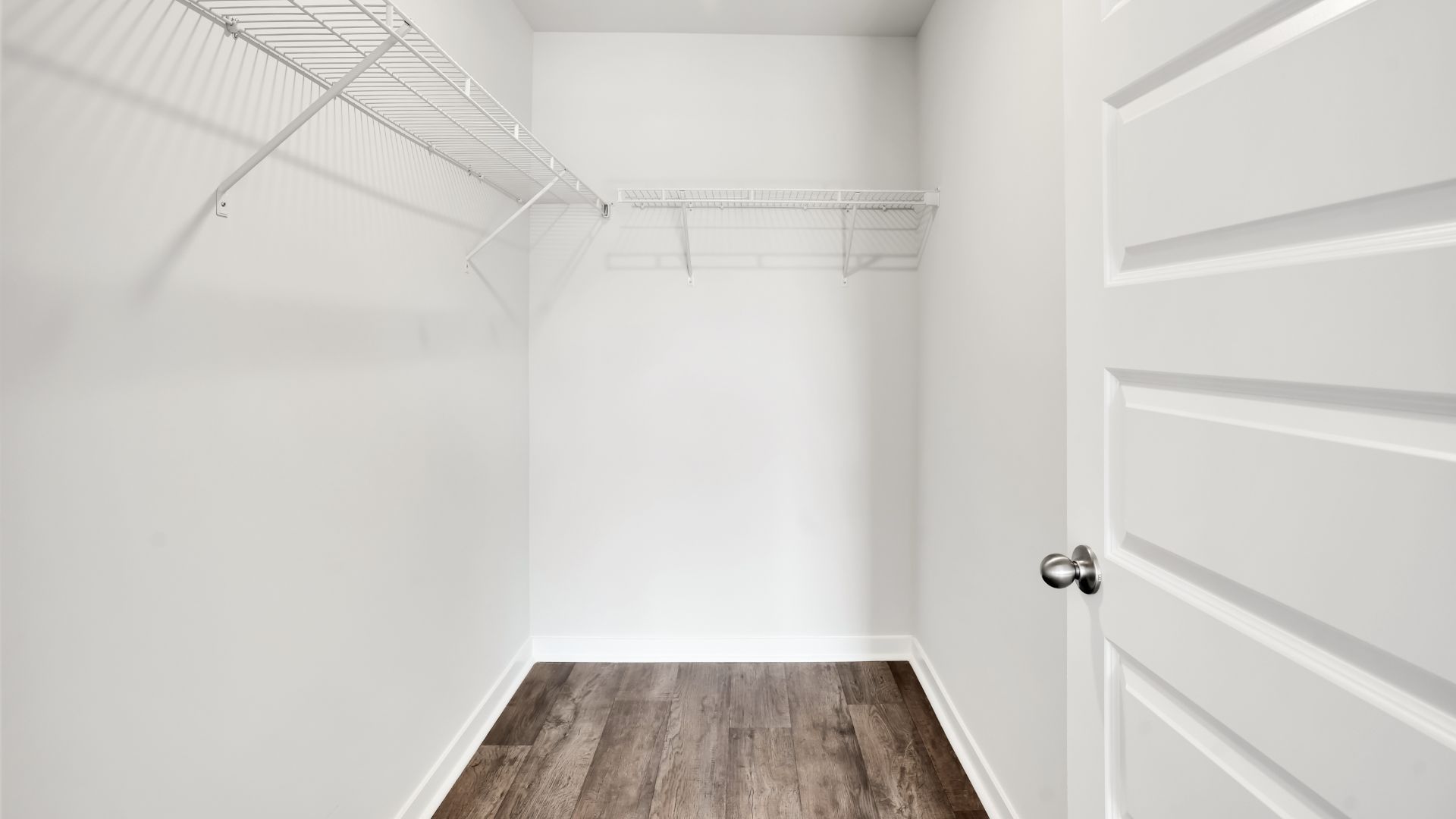 The primary bedroom features an ensuite bathroom with a double vanity, granite countertops, and walk-in closet. Each bedroom has vinyl flooring along with a closet that are versatile to fit your family's needs, whether they become bedrooms or home offices.