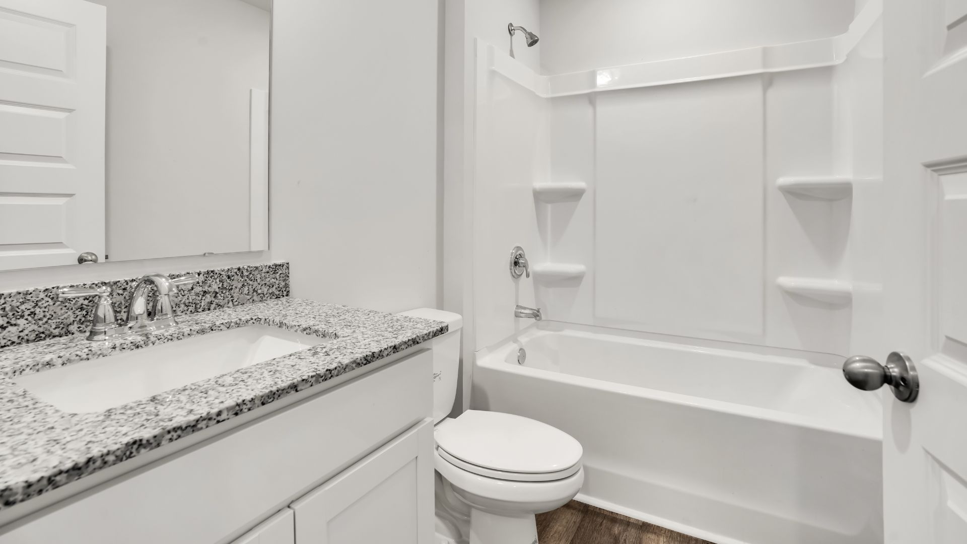 The primary bedroom features an ensuite bathroom with a double vanity, granite countertops, and walk-in closet. Each bedroom has vinyl flooring along with a closet that are versatile to fit your family's needs, whether they become bedrooms or home offices.