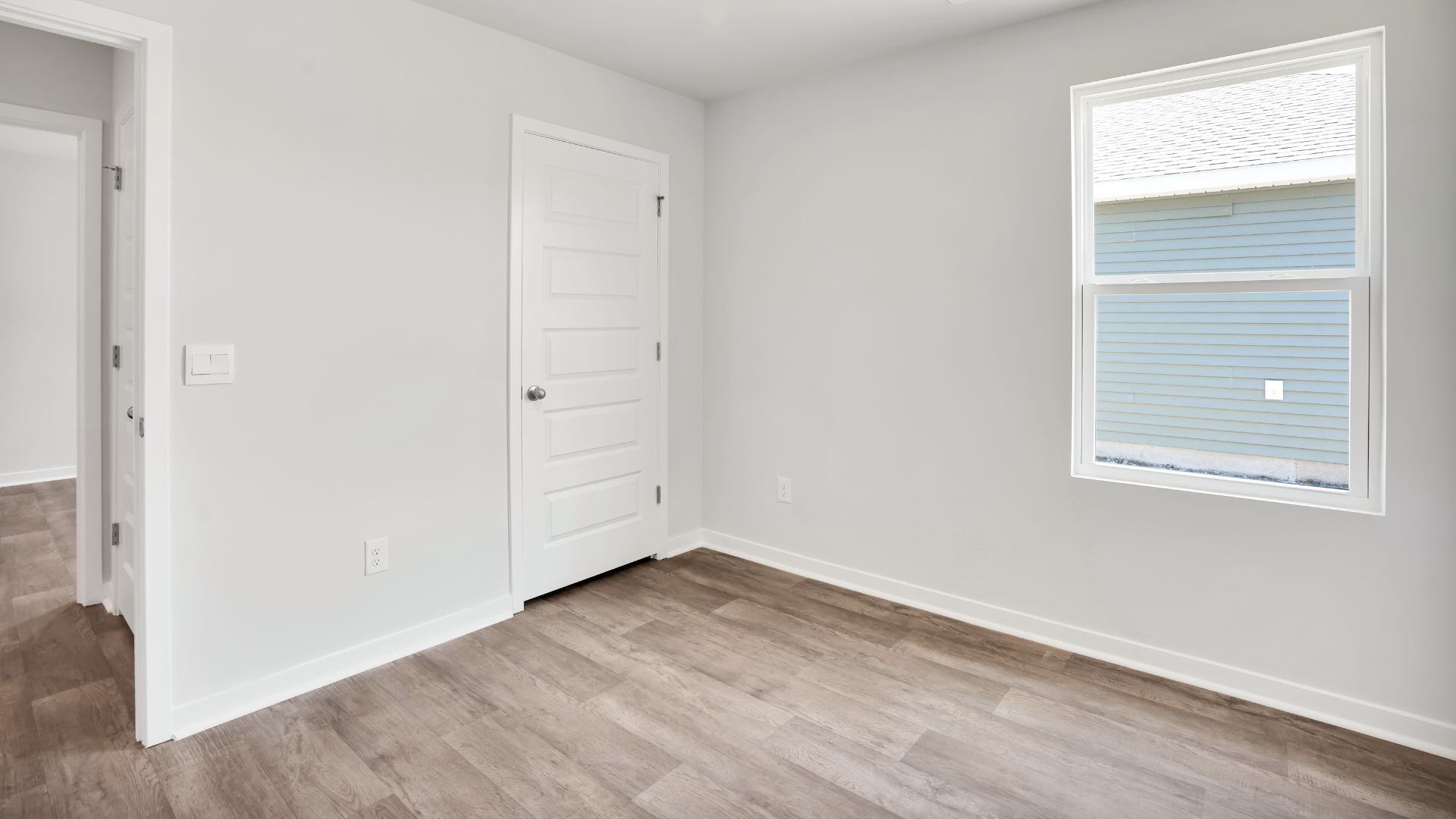 The primary bedroom features an ensuite bathroom with a double vanity, granite countertops, and walk-in closet. Each bedroom has vinyl flooring along with a closet that are versatile to fit your family's needs, whether they become bedrooms or home offices.
