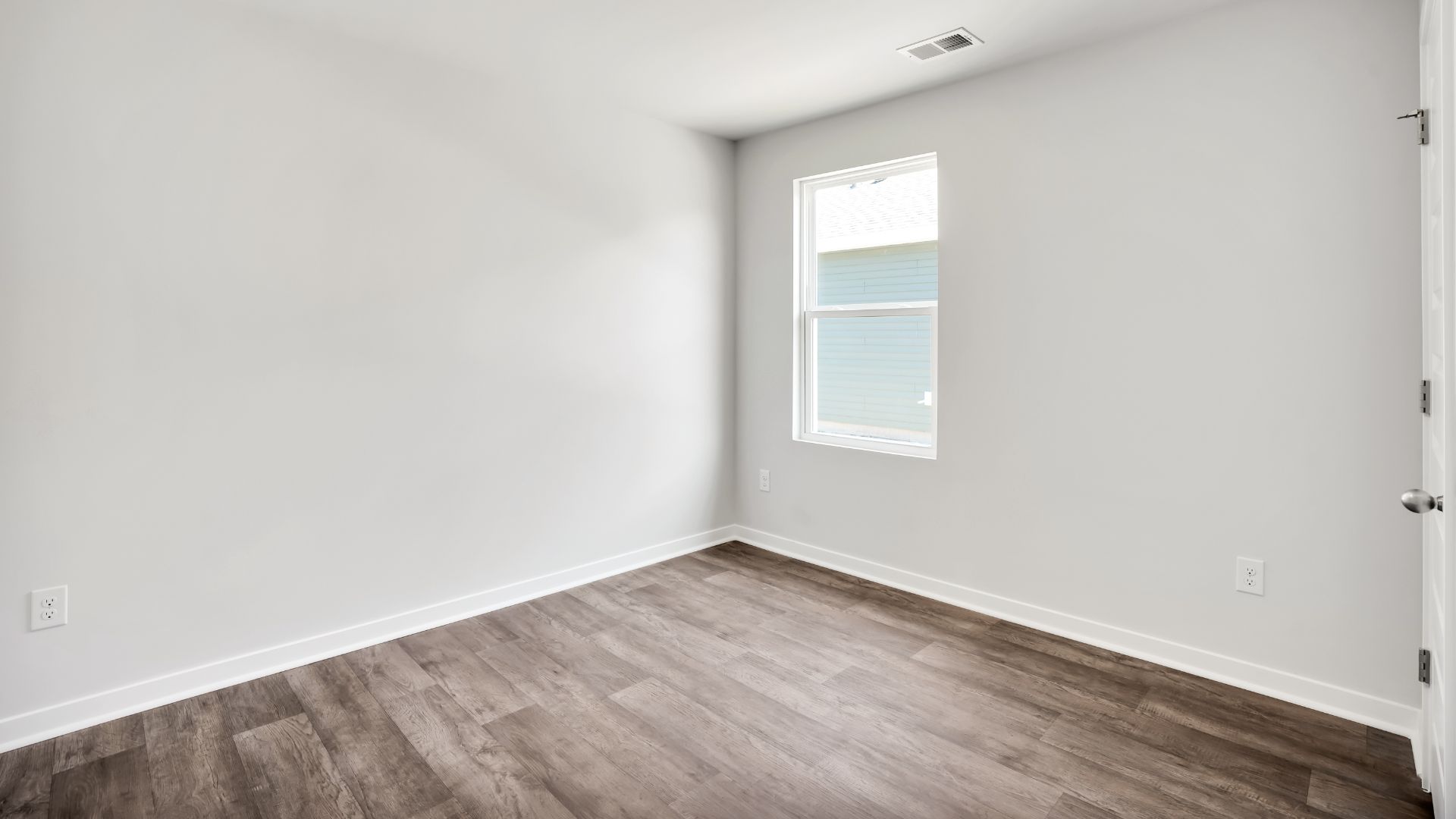 The primary bedroom features an ensuite bathroom with a double vanity, granite countertops, and walk-in closet. Each bedroom has vinyl flooring along with a closet that are versatile to fit your family's needs, whether they become bedrooms or home offices.