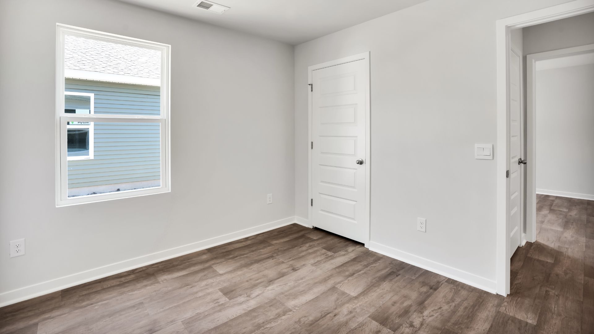 The primary bedroom features an ensuite bathroom with a double vanity, granite countertops, and walk-in closet. Each bedroom has vinyl flooring along with a closet that are versatile to fit your family's needs, whether they become bedrooms or home offices.