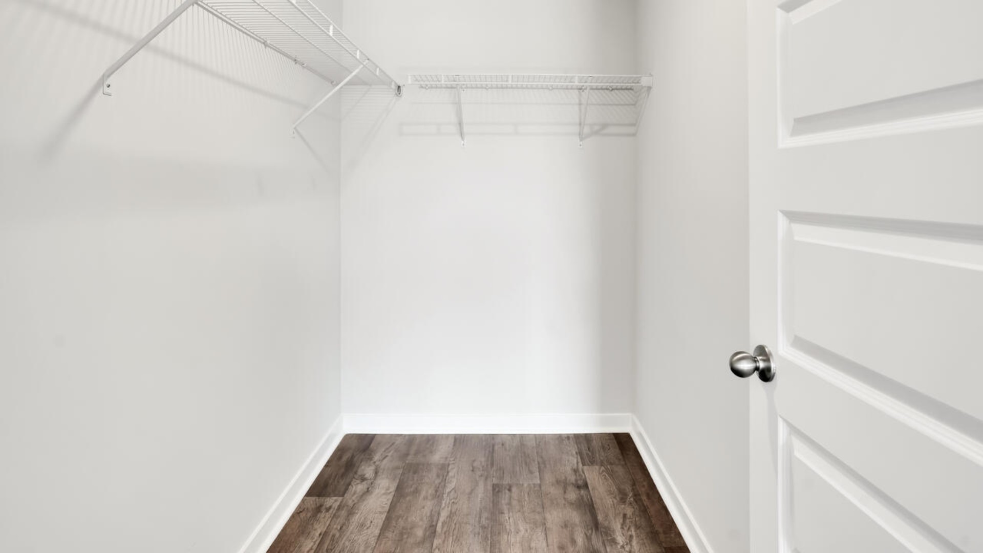 The primary bedroom features an ensuite bathroom with a double vanity, granite countertops, and walk-in closet . Each bedroom has vinyl flooring along with a closet that are versatile to fit your family's needs, whether they become bedrooms or home offices