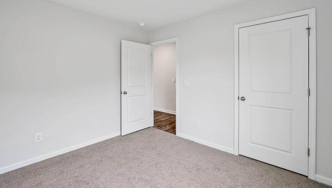 The primary bedroom features an ensuite bathroom with a double vanity, granite countertops, and walk-in closet . Each bedroom has carpeted floors along with a closet that are versatile to fit your family's needs, whether they become bedrooms or home offices.