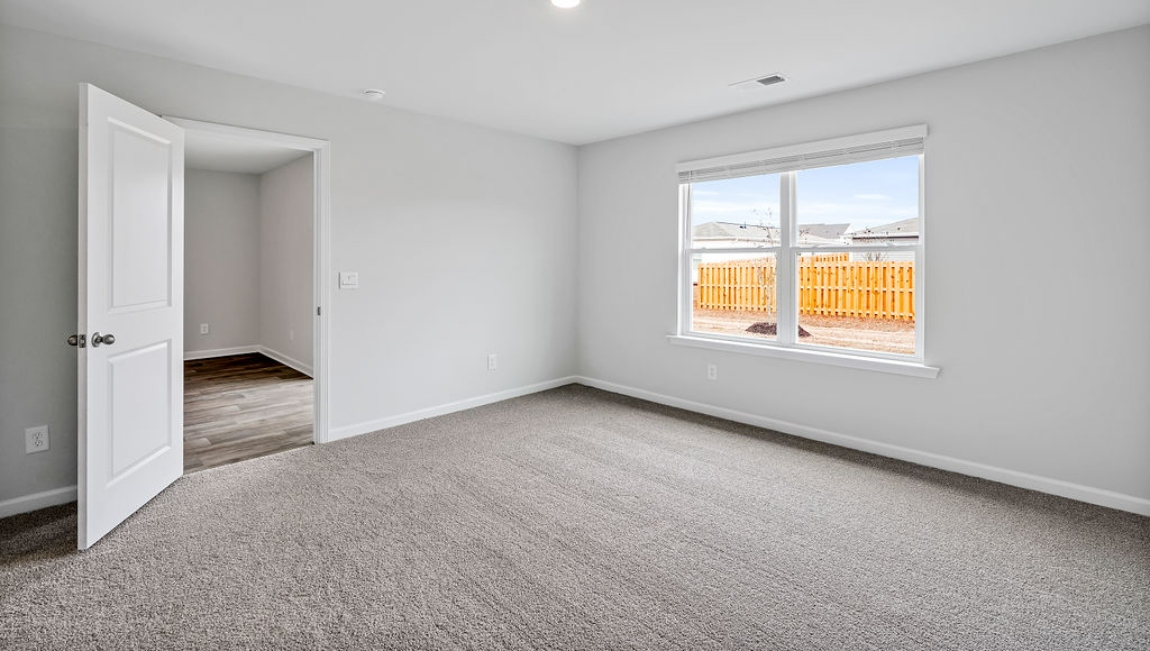 The primary bedroom features an ensuite bathroom with a double vanity, granite countertops, and walk-in closet . Each bedroom has carpeted floors along with a closet that are versatile to fit your family's needs, whether they become bedrooms or home offices.