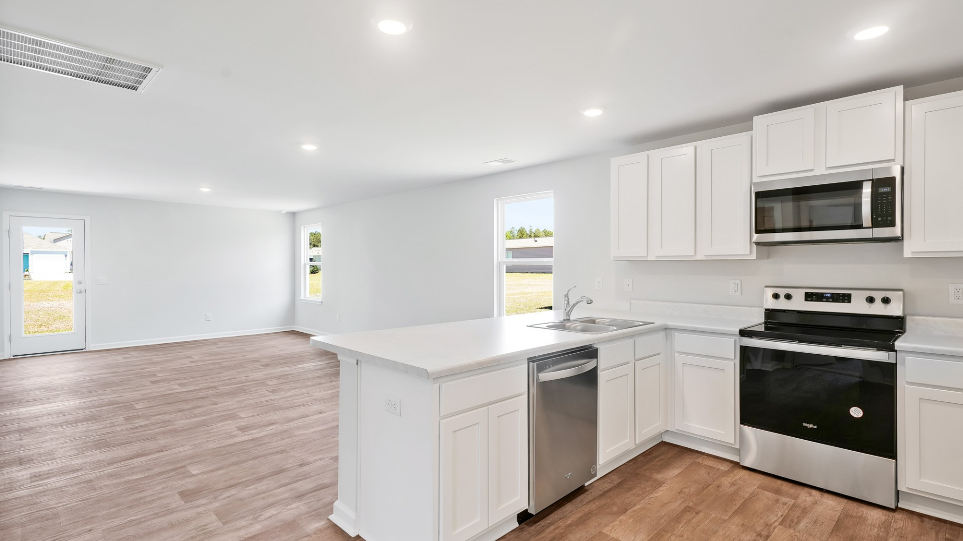 The kitchen features shaker-style cabinets, granite countertops, and stainless-steel appliances, which are sure to both turn heads and make meal prep easy.