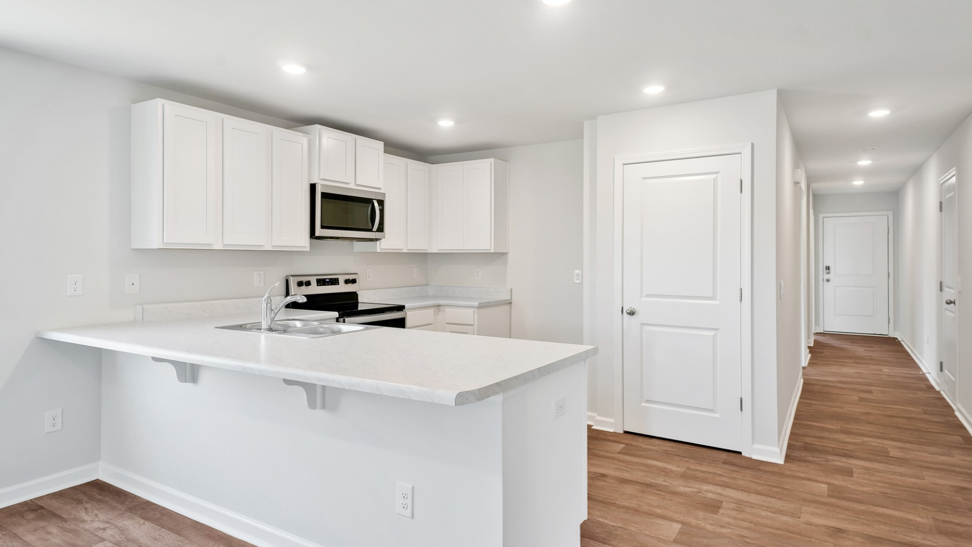 The kitchen features shaker-style cabinets, granite countertops, and stainless-steel appliances, which are sure to both turn heads and make meal prep easy.