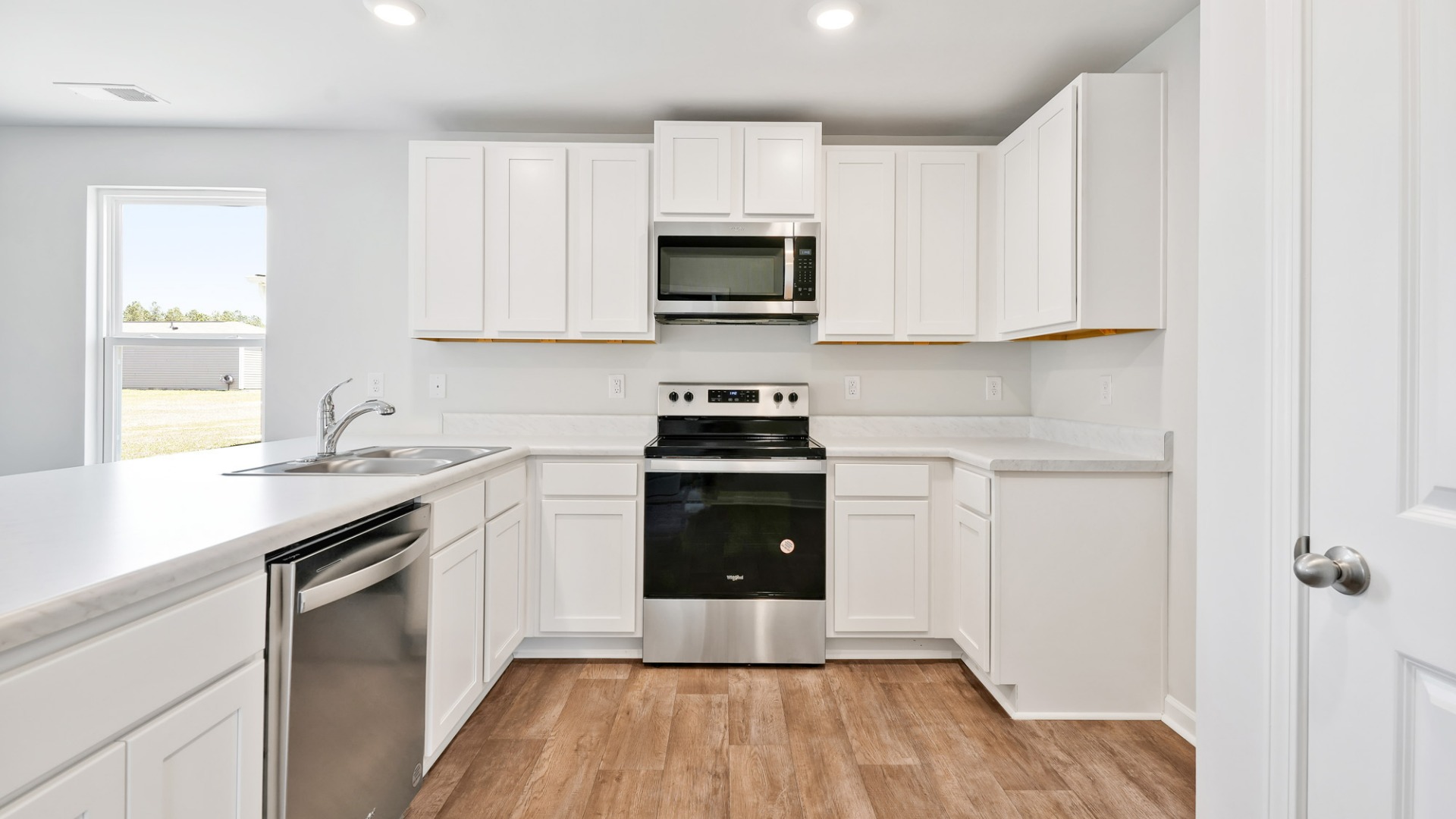 The kitchen features shaker-style cabinets, granite countertops, and stainless-steel appliances, which are sure to both turn heads and make meal prep easy.