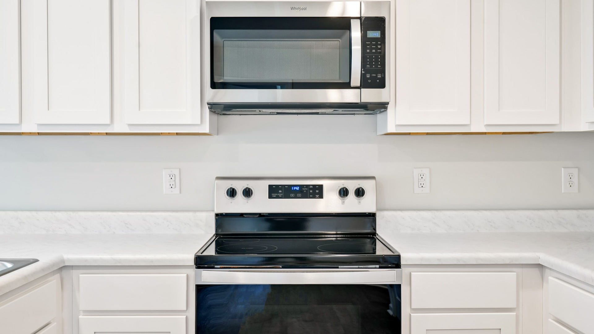 The kitchen features shaker-style cabinets, granite countertops, and stainless-steel appliances, which are sure to both turn heads and make meal prep easy.