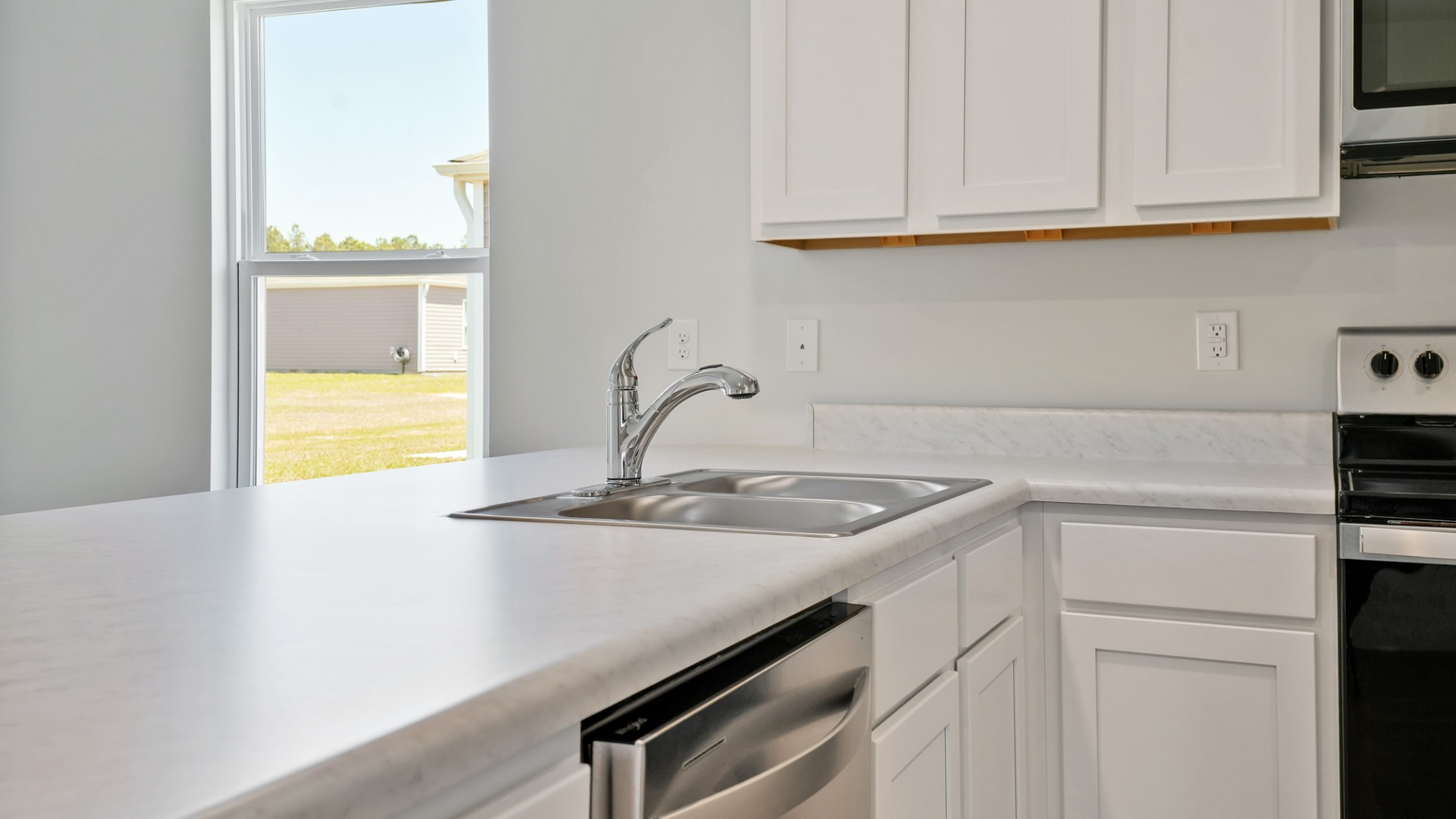 The kitchen features shaker-style cabinets, granite countertops, and stainless-steel appliances, which are sure to both turn heads and make meal prep easy.