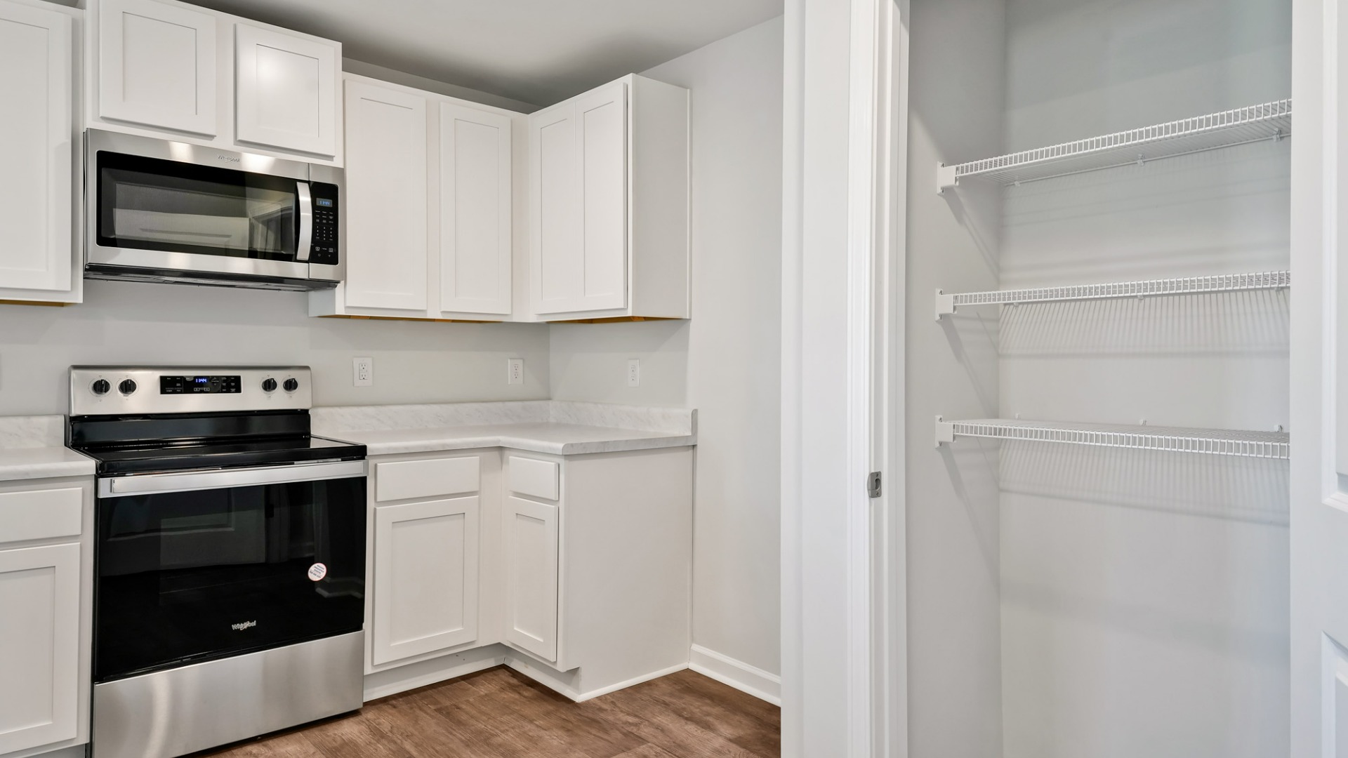 The kitchen features shaker-style cabinets, granite countertops, and stainless-steel appliances, which are sure to both turn heads and make meal prep easy.