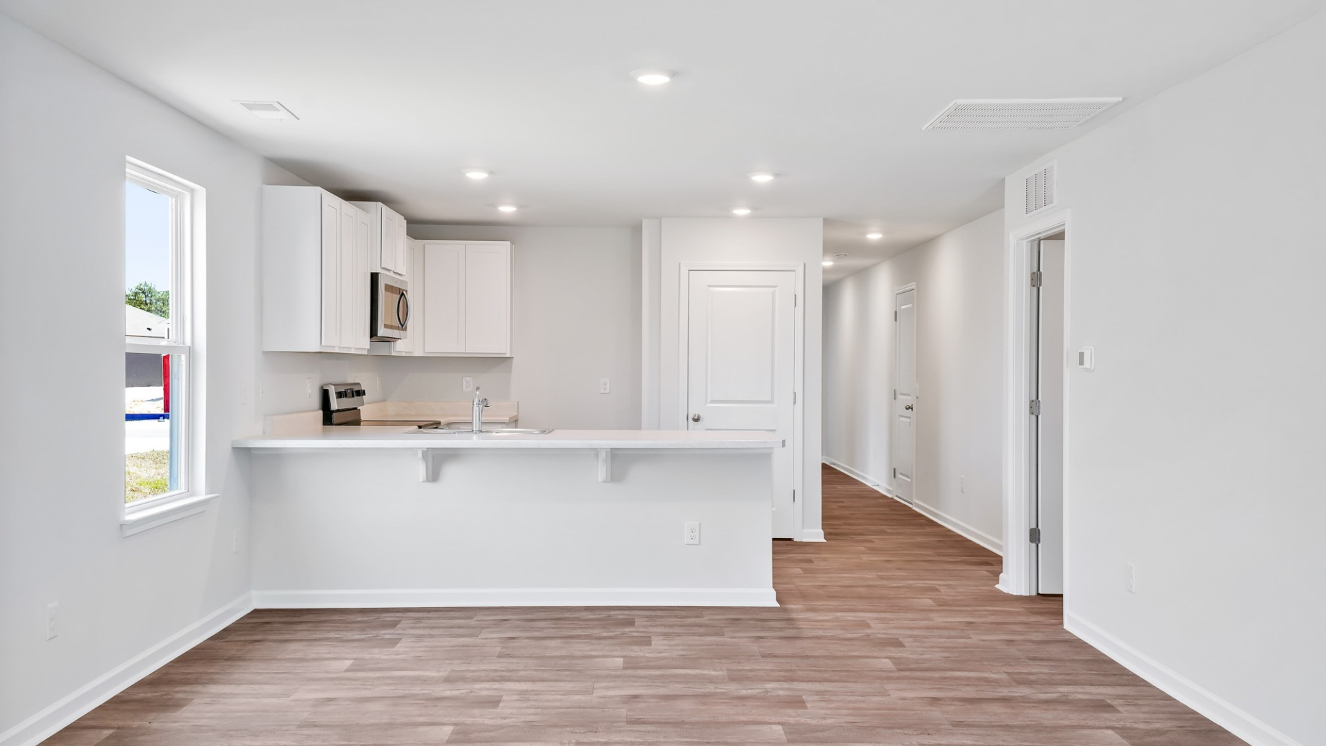 The kitchen features shaker-style cabinets, granite countertops, and stainless-steel appliances, which are sure to both turn heads and make meal prep easy.