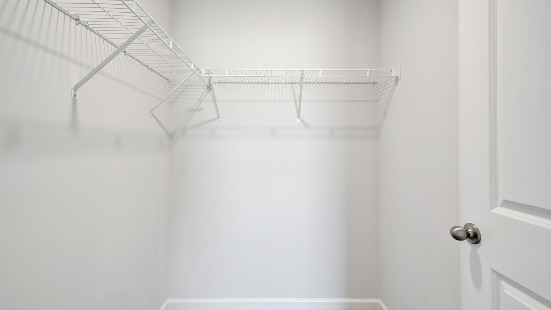 Nestled at the rear of the house, the primary bedroom has ample privacy. This layout is idea for those seeking practicality and relaxation in their living space.