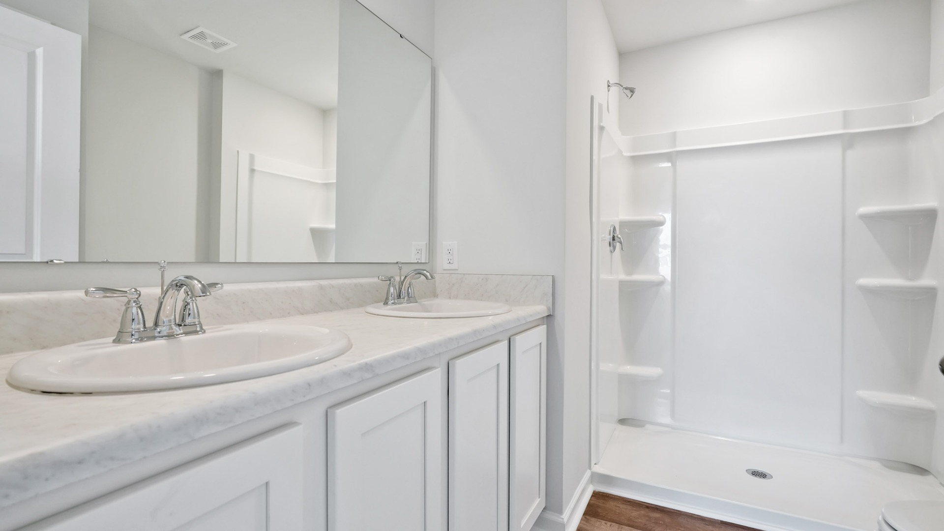 Nestled at the rear of the house, the primary bedroom has ample privacy. This layout is idea for those seeking practicality and relaxation in their living space.