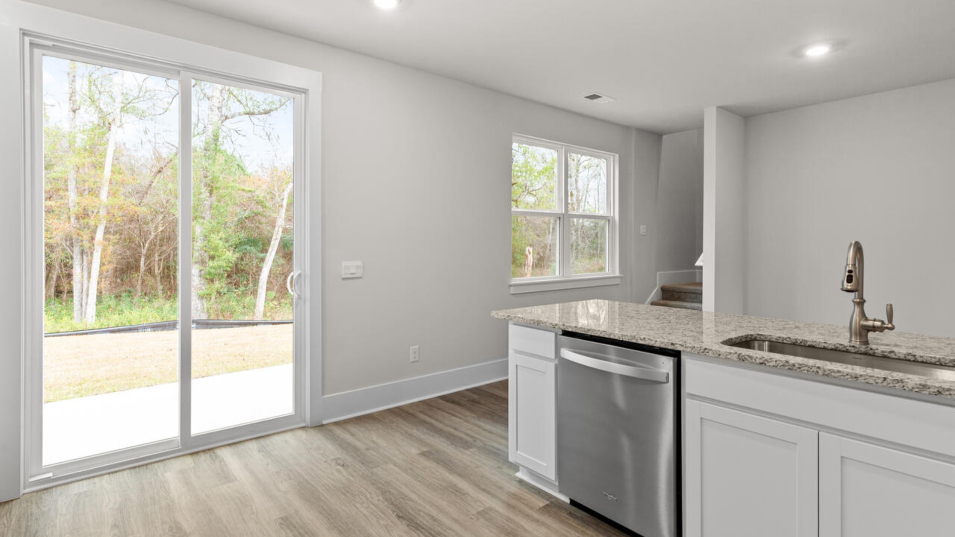 Entering the home we find a large family room and dining area that's perfect for entertaining. The heart of the home is the kitchen features granite counters, stainless-steel appliances and a large peninsula island with room for 4 counter height barstools.