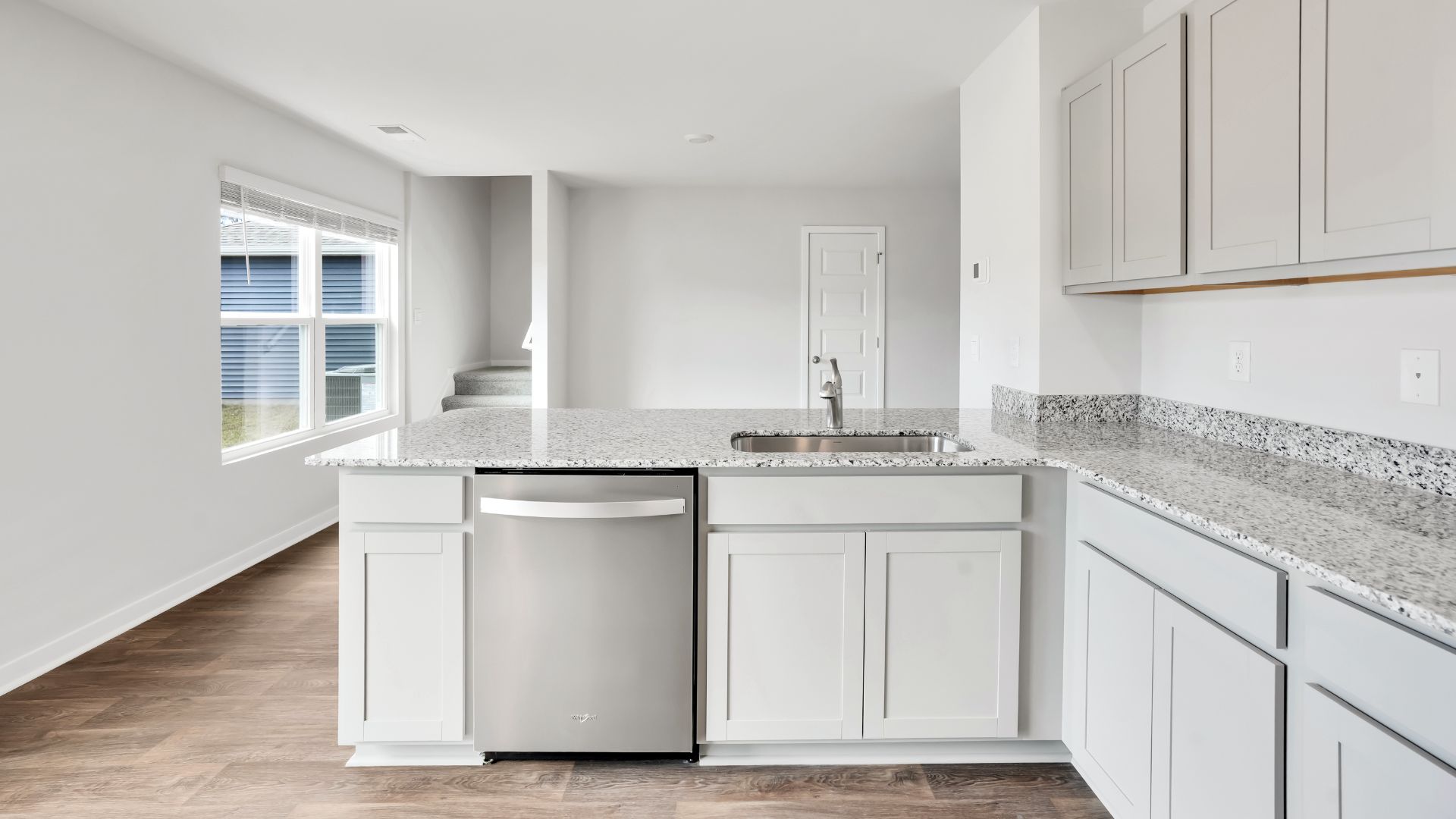 Entering the home we find a large family room and dining area that's perfect for entertaining. The heart of the home is the kitchen features granite counters, stainless-steel appliances and a large peninsula island with room for 4 counter height barstools.