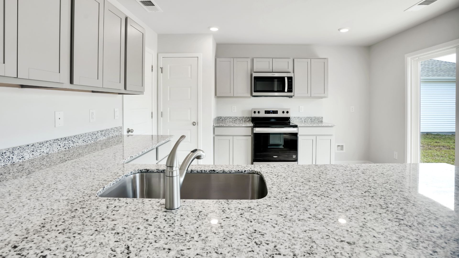 Entering the home we find a large family room and dining area that's perfect for entertaining. The heart of the home is the kitchen features granite counters, stainless-steel appliances and a large peninsula island with room for 4 counter height barstools.