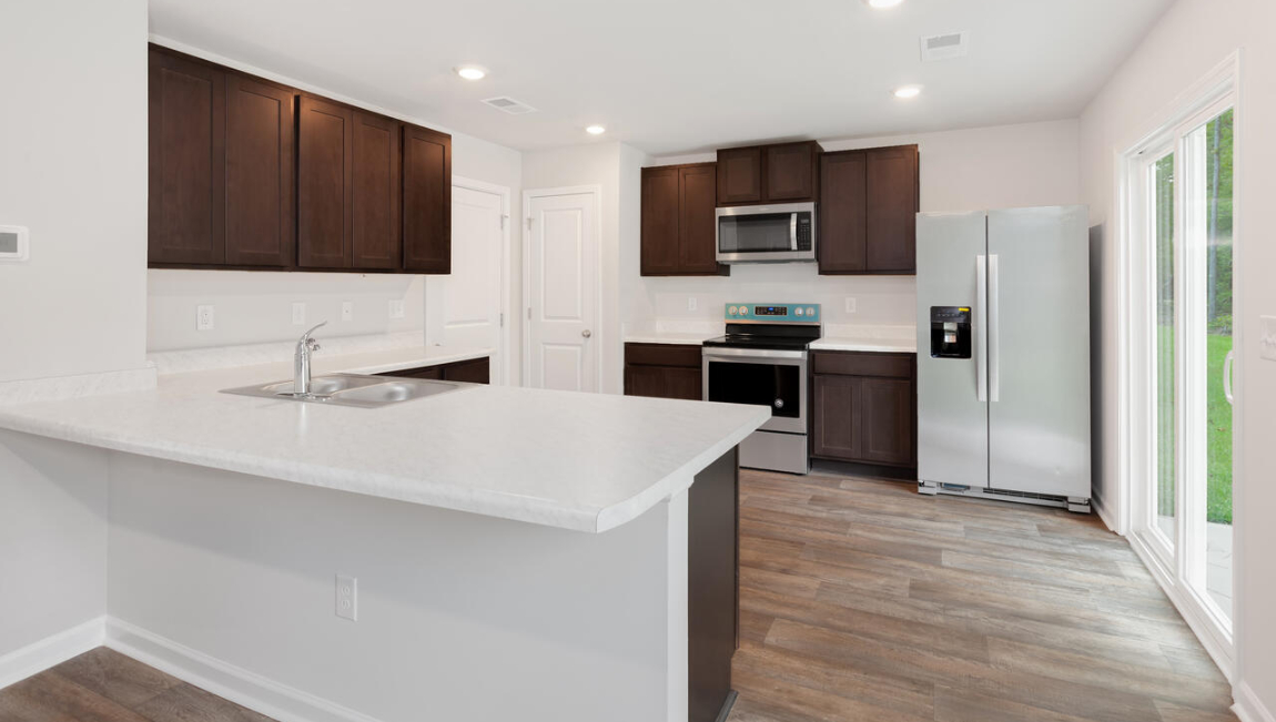 Entering the home we find a large family room and dining area that's perfect for entertaining. The heart of the home is the kitchen features granite counters, stainless-steel appliances and a large peninsula island with room for 4 counter height barstools.