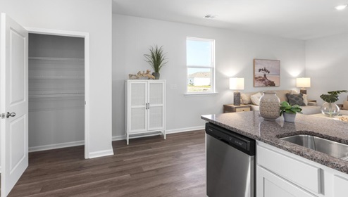 The kitchen is equipped for both efficiency and style with all stainless-steel appliances, including a range, built-in dishwasher, refrigerator, and microwave.