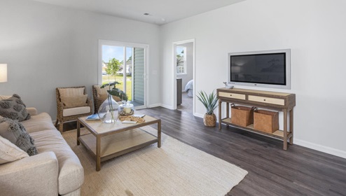 The kitchen is equipped for both efficiency and style with all stainless-steel appliances, including a range, built-in dishwasher, refrigerator, and microwave.
