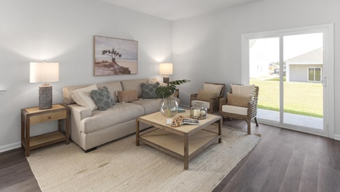 The kitchen is equipped for both efficiency and style with all stainless-steel appliances, including a range, built-in dishwasher, refrigerator, and microwave.
