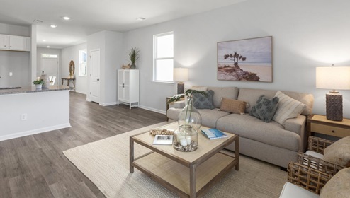 The kitchen is equipped for both efficiency and style with all stainless-steel appliances, including a range, built-in dishwasher, refrigerator, and microwave.
